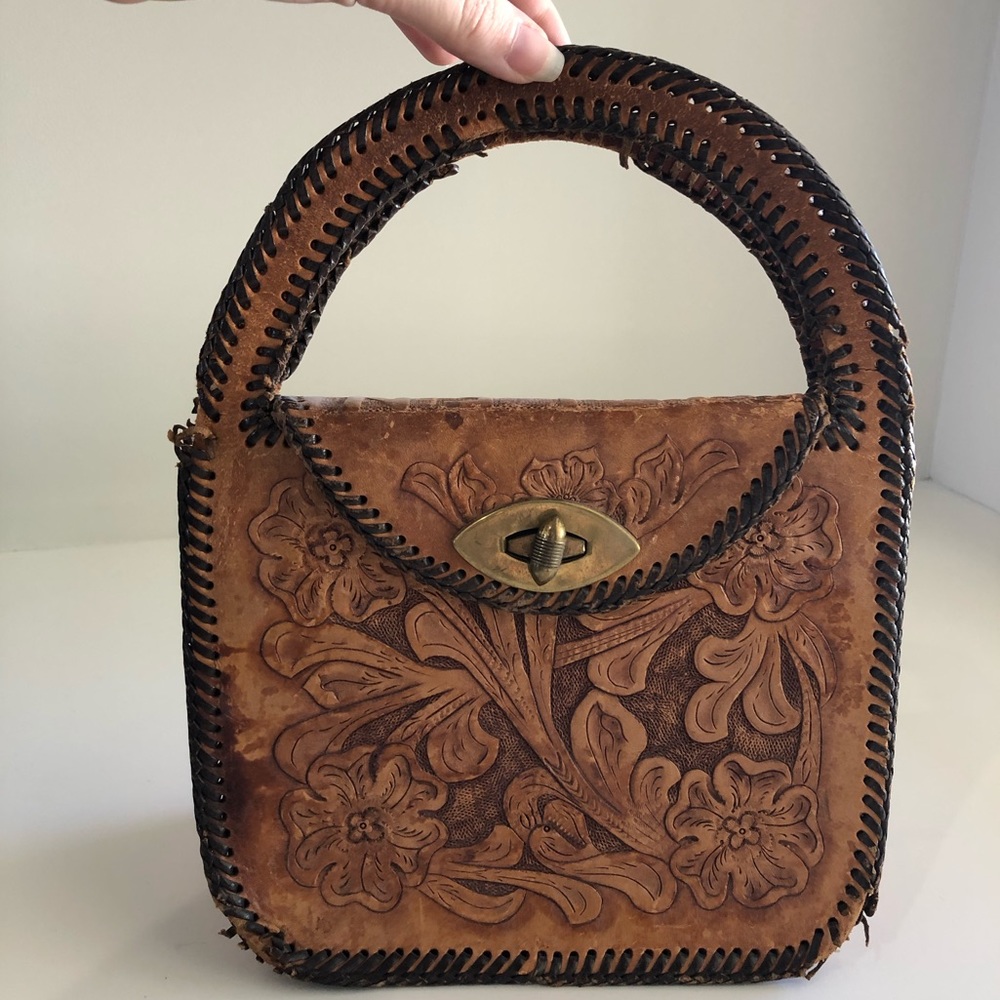 Hand tooled carved leather purse. Top handle.